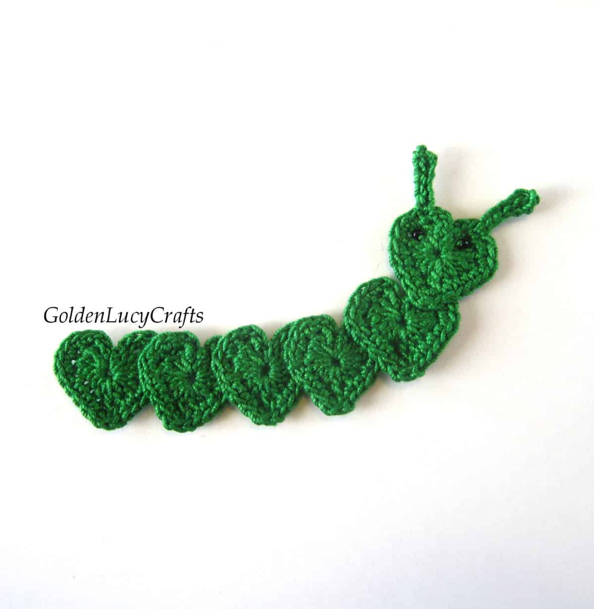 Crocheted green caterpillar made from hearts.