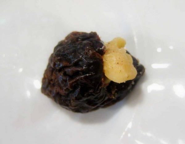 Prunes stuffed with walnuts in sweet cream