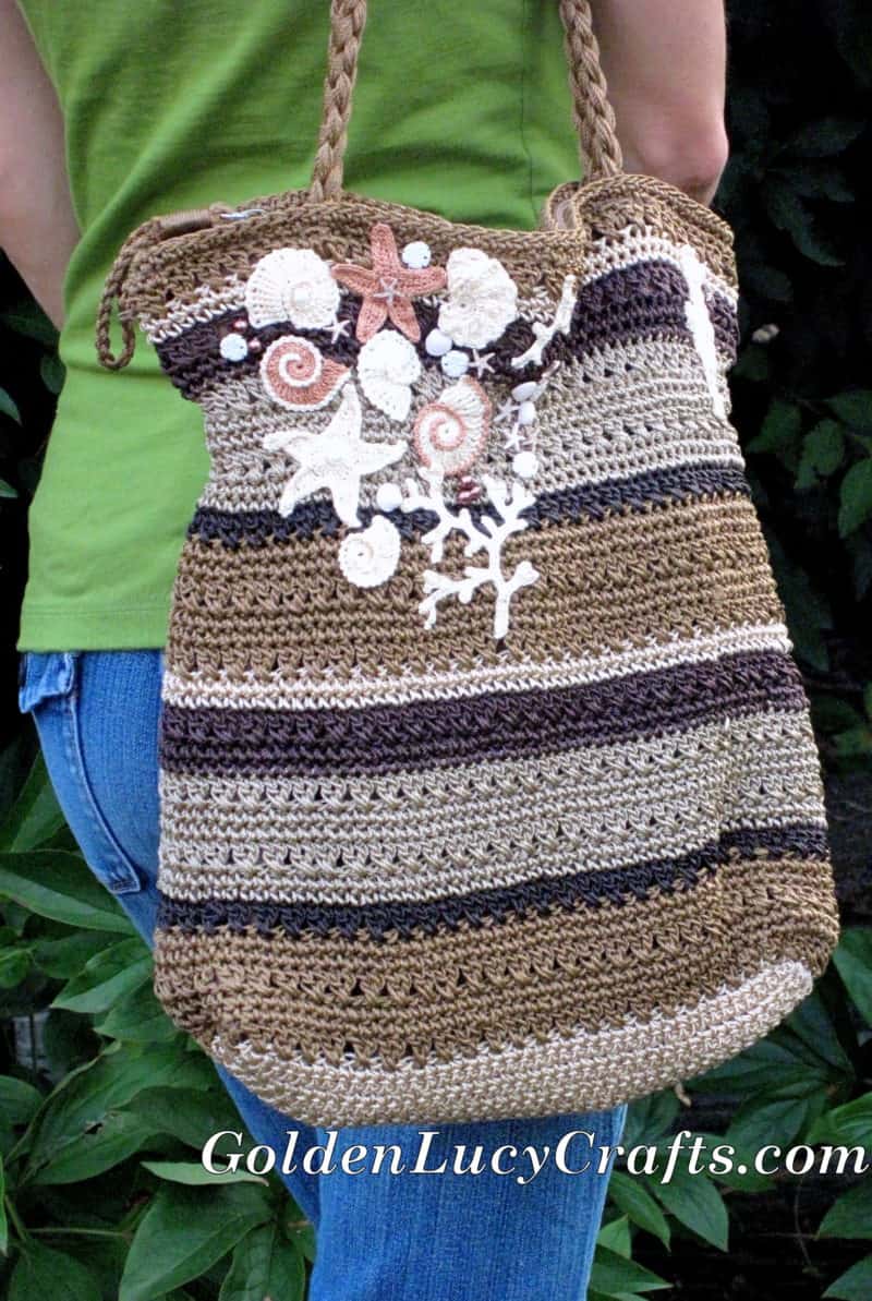 Model with crocheted bag embellished with appliques