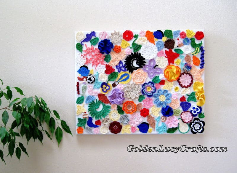 Crochet wall art made from many different crocheted peices glued to the canvas.