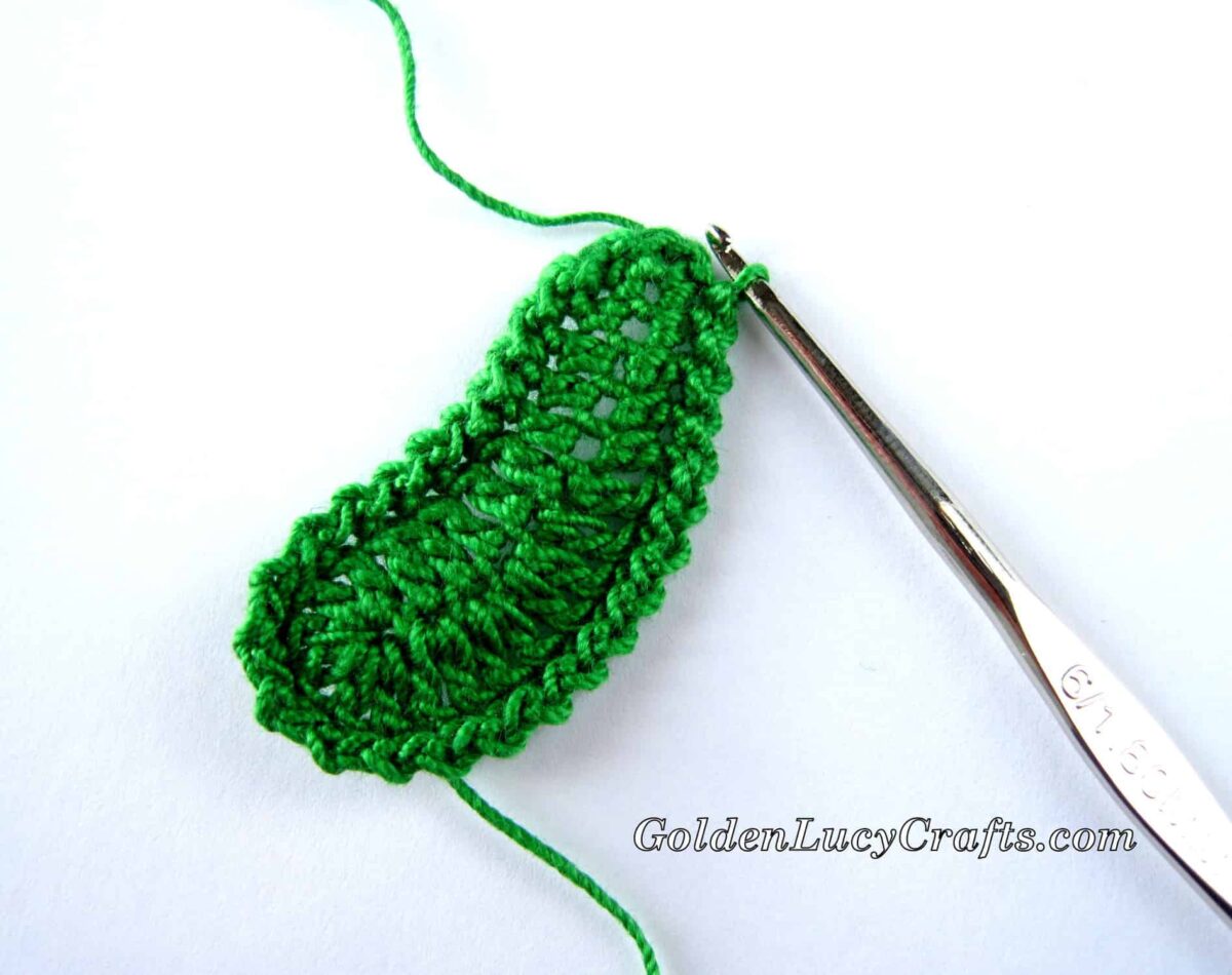 Crocheting green leaf making a boarder.
