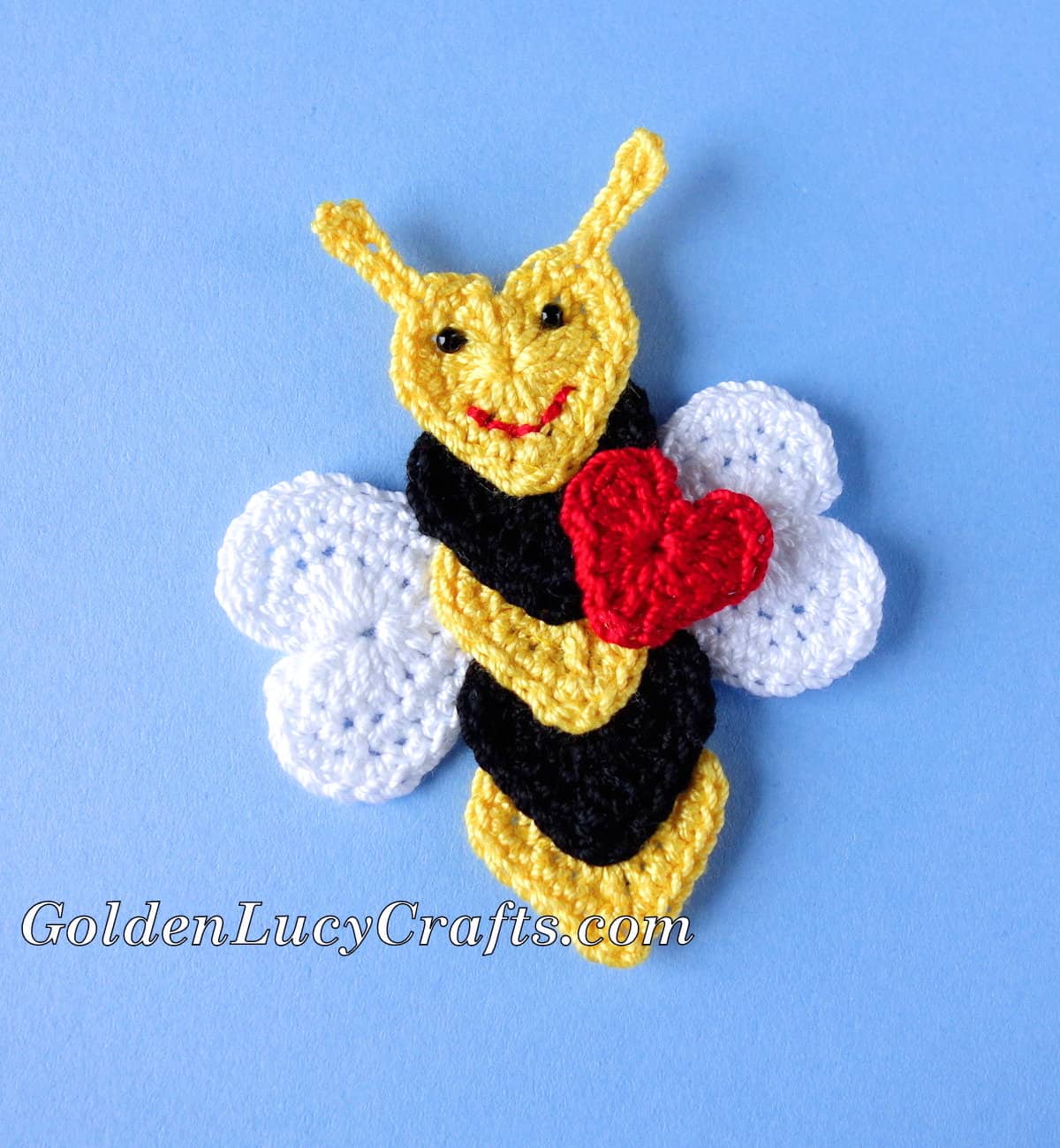 Crochet bee applique made from hearts.