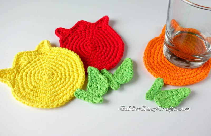 Crochet tulip coasters and a glass.