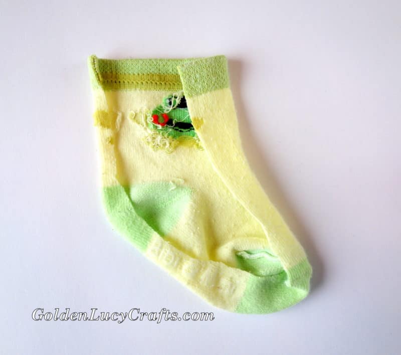 Baby sock with trimmed front layer.