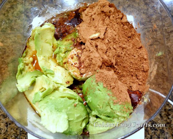Avocadoes, maple syrup and cocoa powder in a mixing bowl