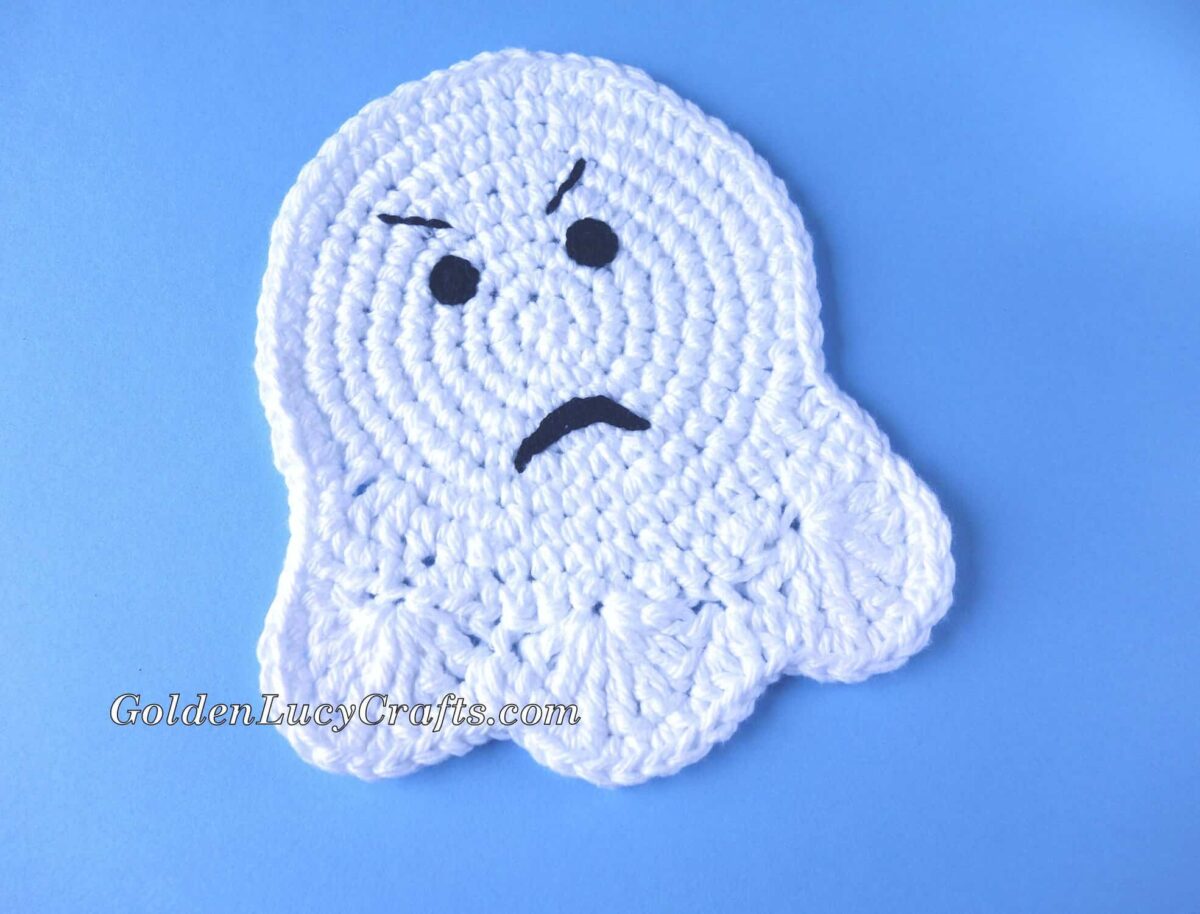 Crochet Ghost Coaster with angry face.