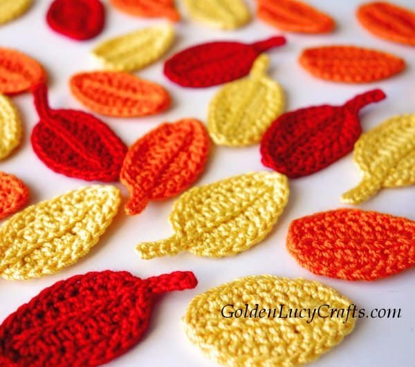 Crocheted leaves in red, yellow and orange colors.