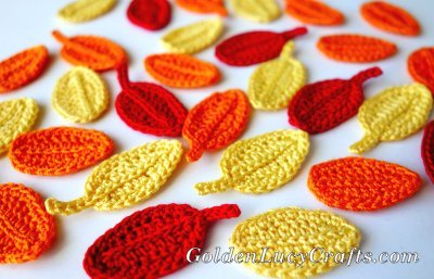 Crocheted fall leaves in red, yellow and orange colors.