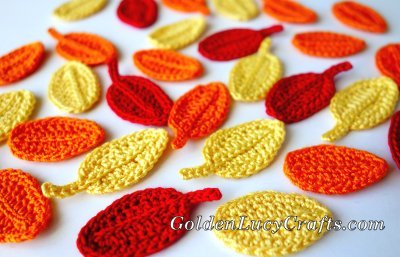 Crocheted leaves in yellow, orange and red colors.