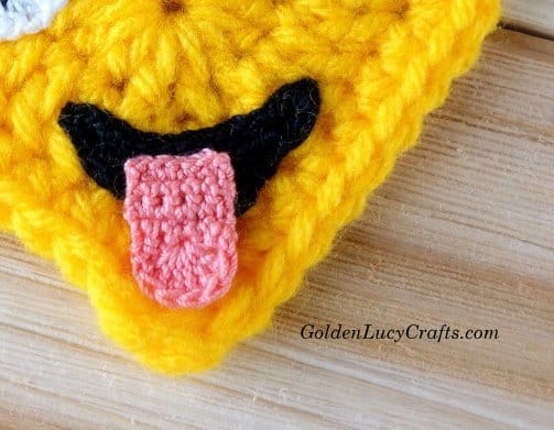 Crochet smile and tongue close up picture.