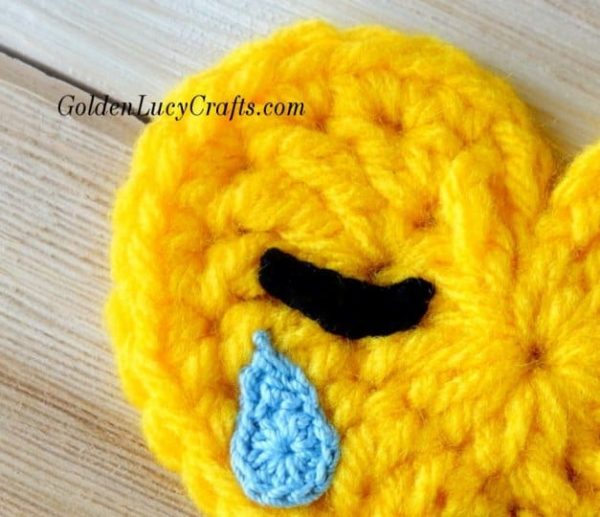 Crochet closed eye with tear close up picture.
