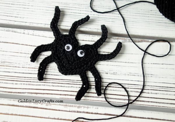 Crochet spider applique and black yarn.