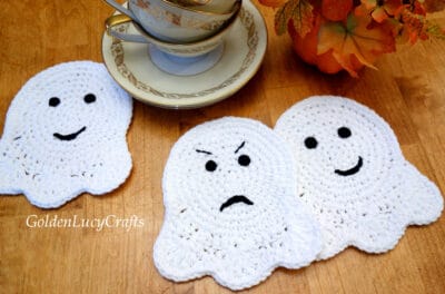 Three crochet ghost coasters.