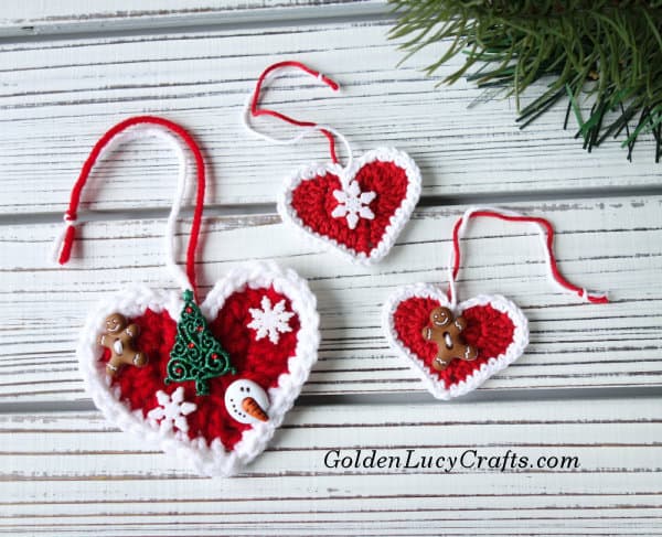 Three crochet Christmas heart ornaments.
