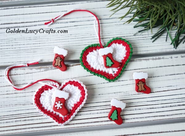 Two Christmas heart ornaments embellished with stockings buttons.