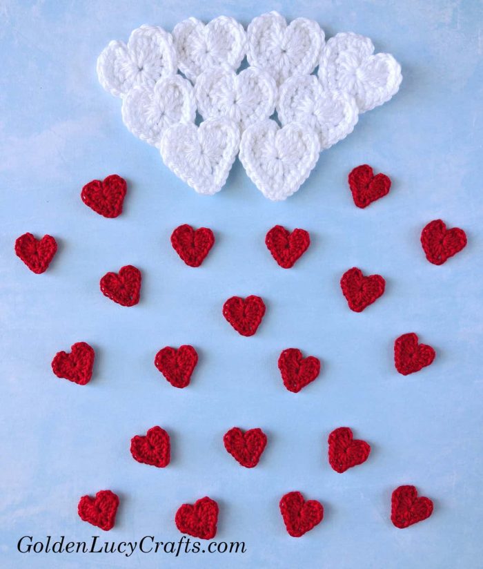 Crochet cloud made from hearts and small red hearts as raindrops.
