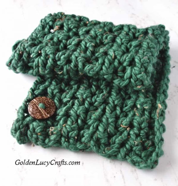 Crocheted bulky green cowl with large wooden button.