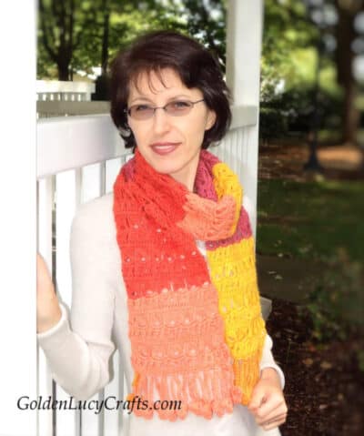 Model is wearing crocheted scarf