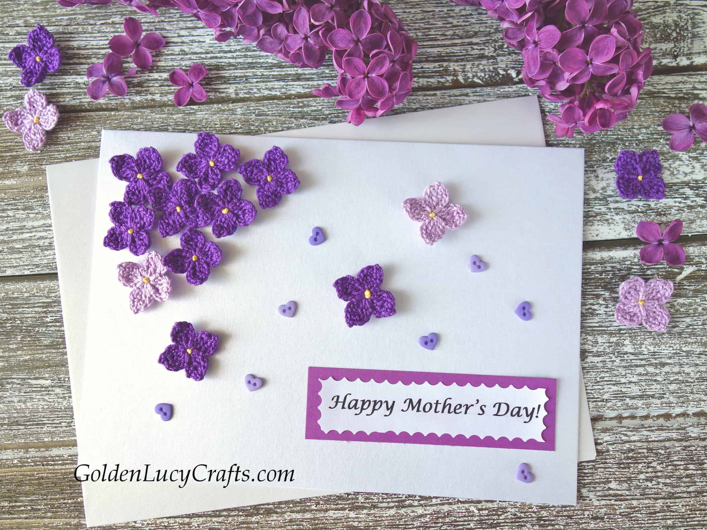 Mother's Day card embellished with crochet lilac flowers, real lilac branch in the background. 