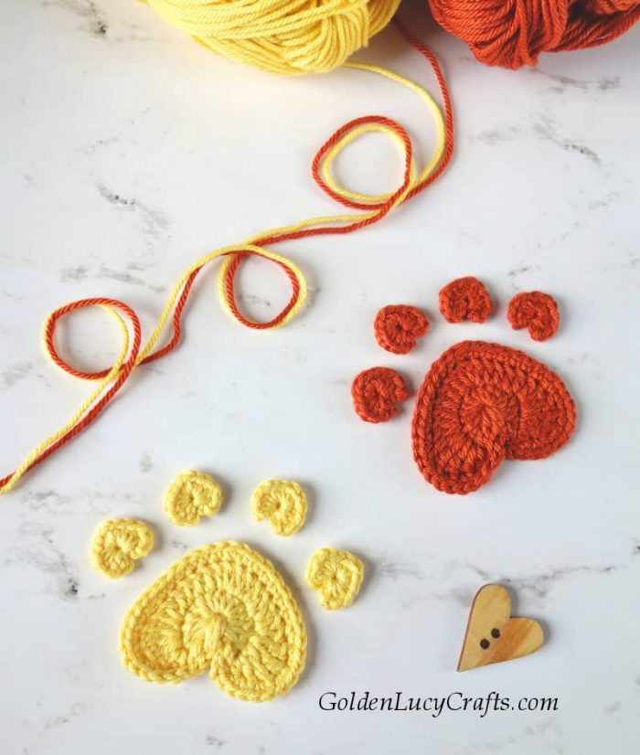 Crochet heart-shaped dog paw print appliques.