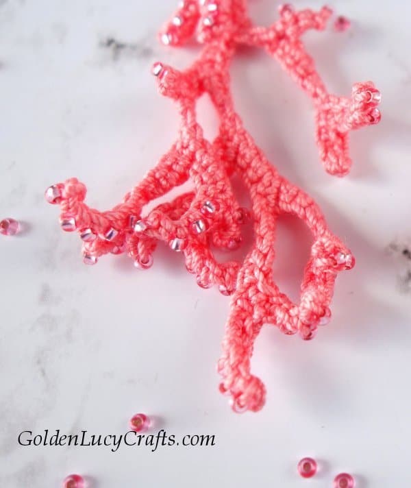 Crochet coral earring, close up image