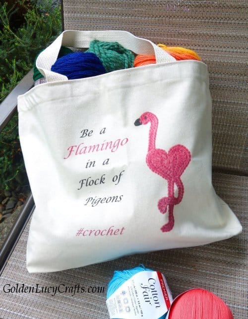 Tote bag full of yarn with pink flamingo on it.