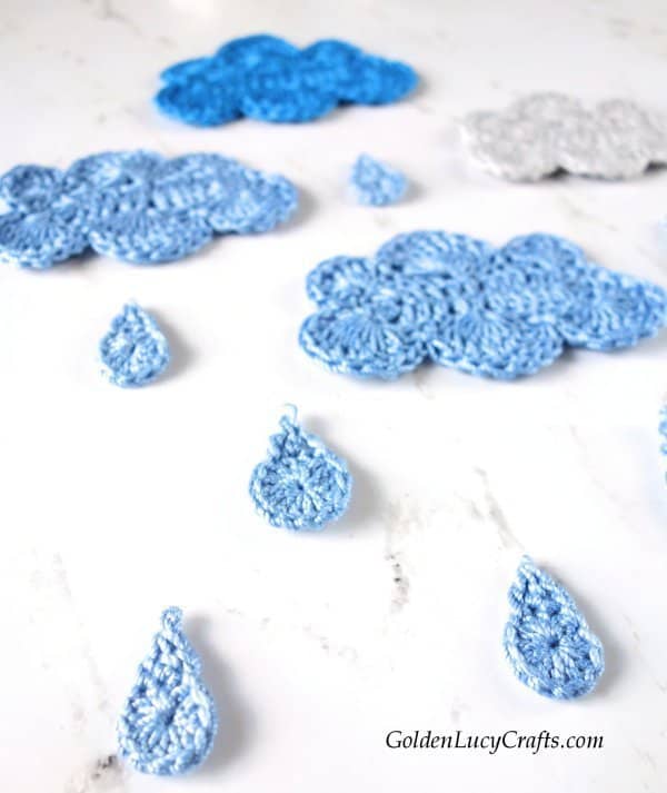 Crochet raindrops and clouds, close up picture.
