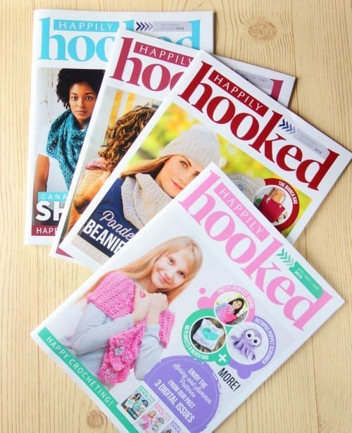 Four crochet magazines laying on the table.