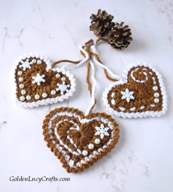Crochet gingerbread hearts and pine cones.