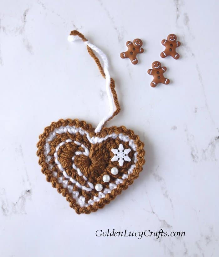 Crochet gingerbread heart ornament, three small gingerbread man buttons.