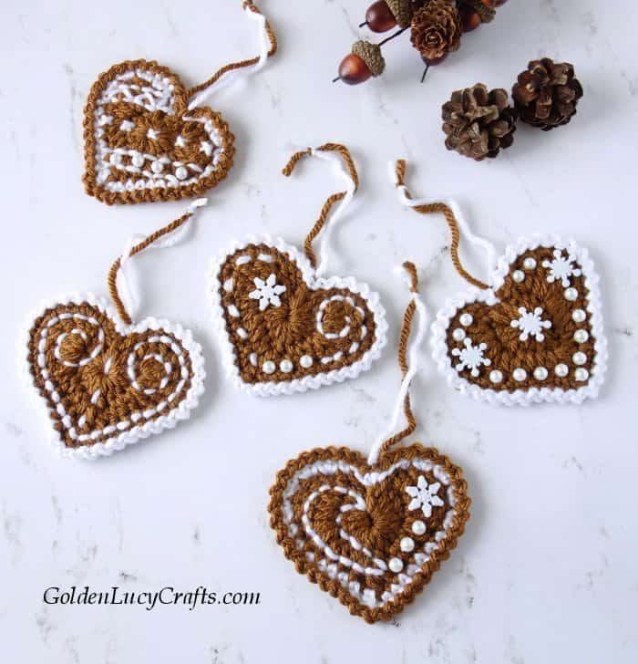 Crocheted five gingerbread heart Christmas ornaments.