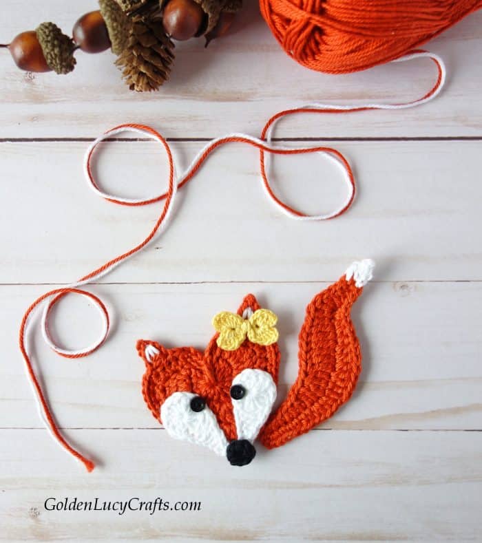 Crochet fox applique, orange yarn and acorns.