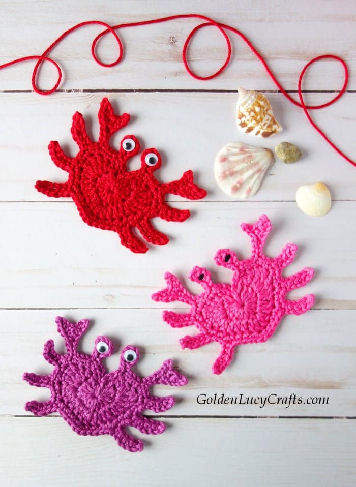 Three crochet crab appliques, sea shells, red yarn.
