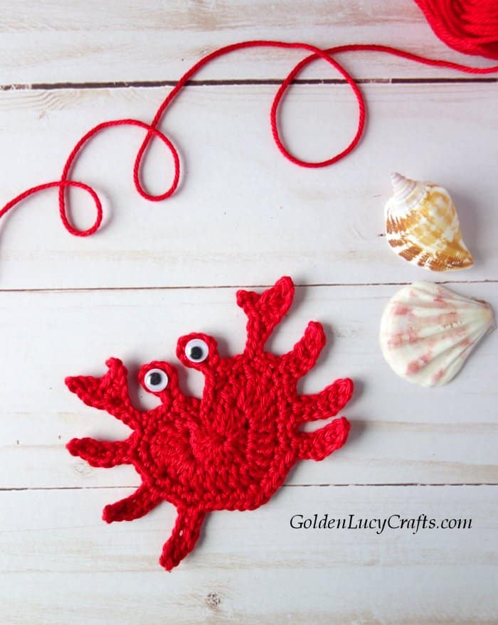 Crochet red heart-shaped crab applique.