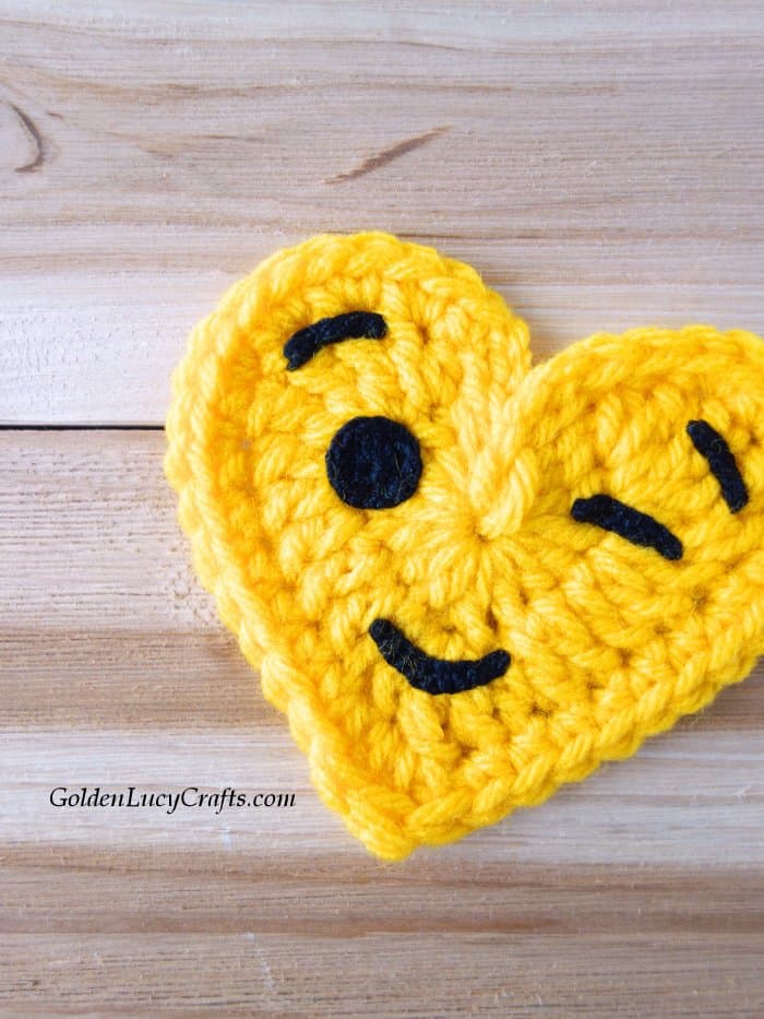 Crochet emoji winking face close up picture.