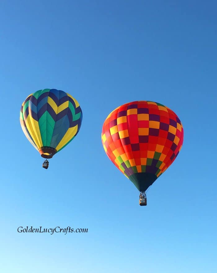 Two hot air balloons flying in the sky.