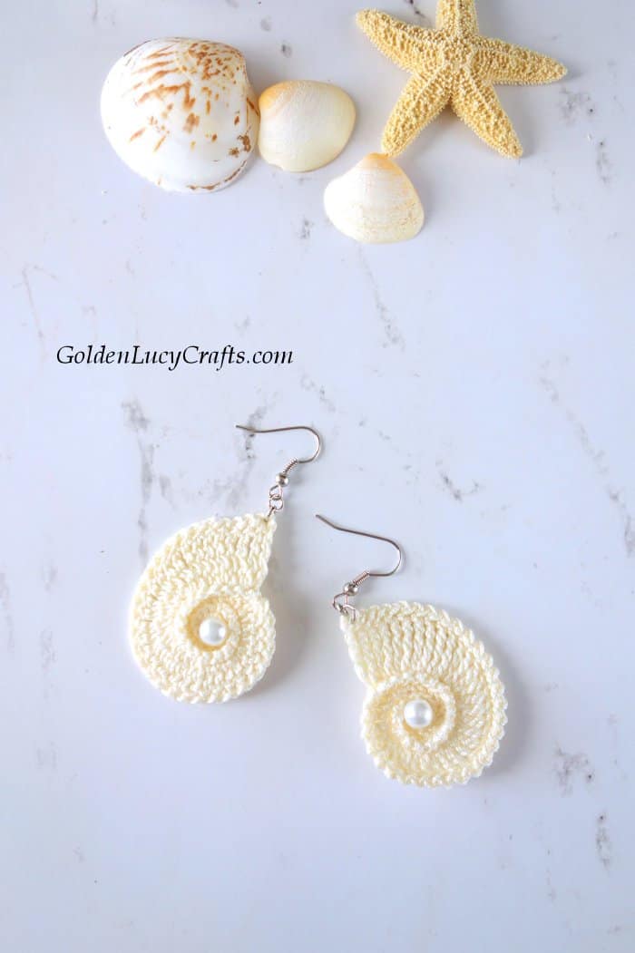 Crochet seashell earrings in cream color, sea shells and sea star as photo props