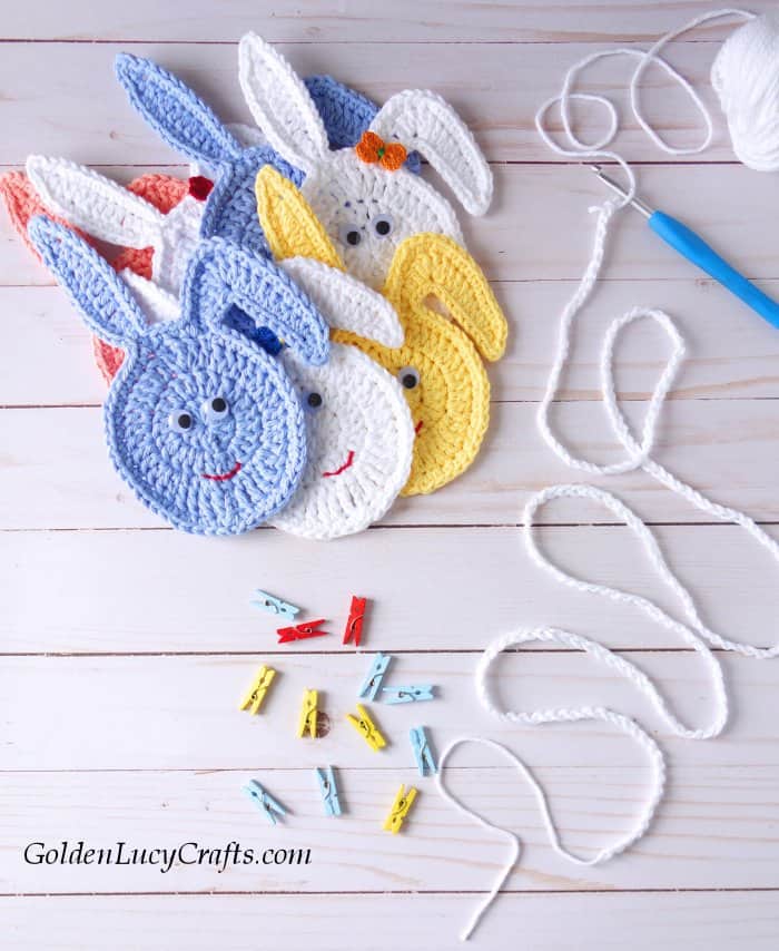 Crocheted bunnies, small craft clothespins and crocheted string.