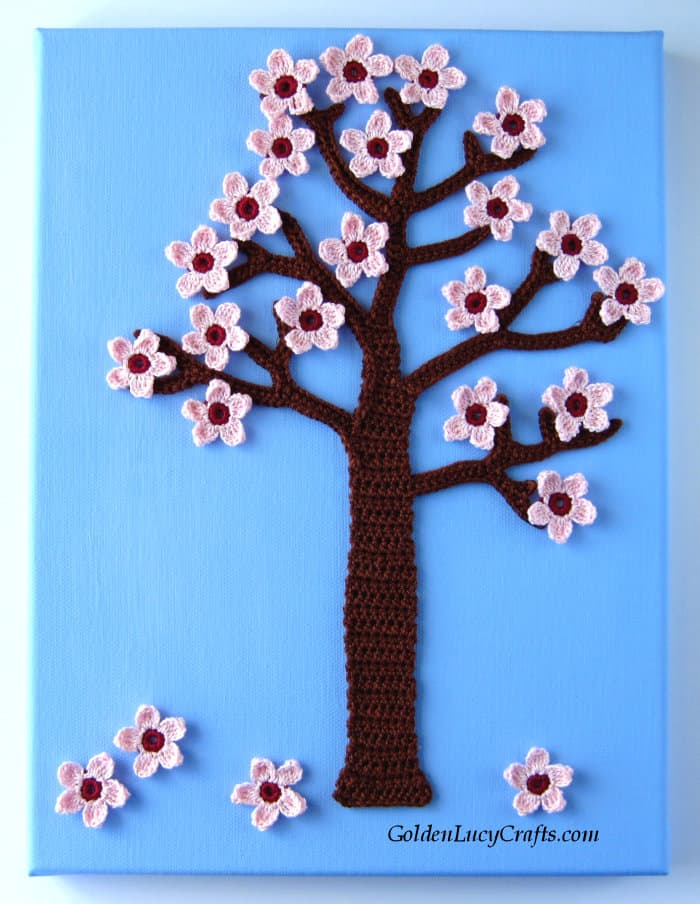 Crocheted spring tree on the blue background.