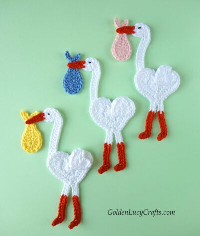 Three crochet stork appliques.