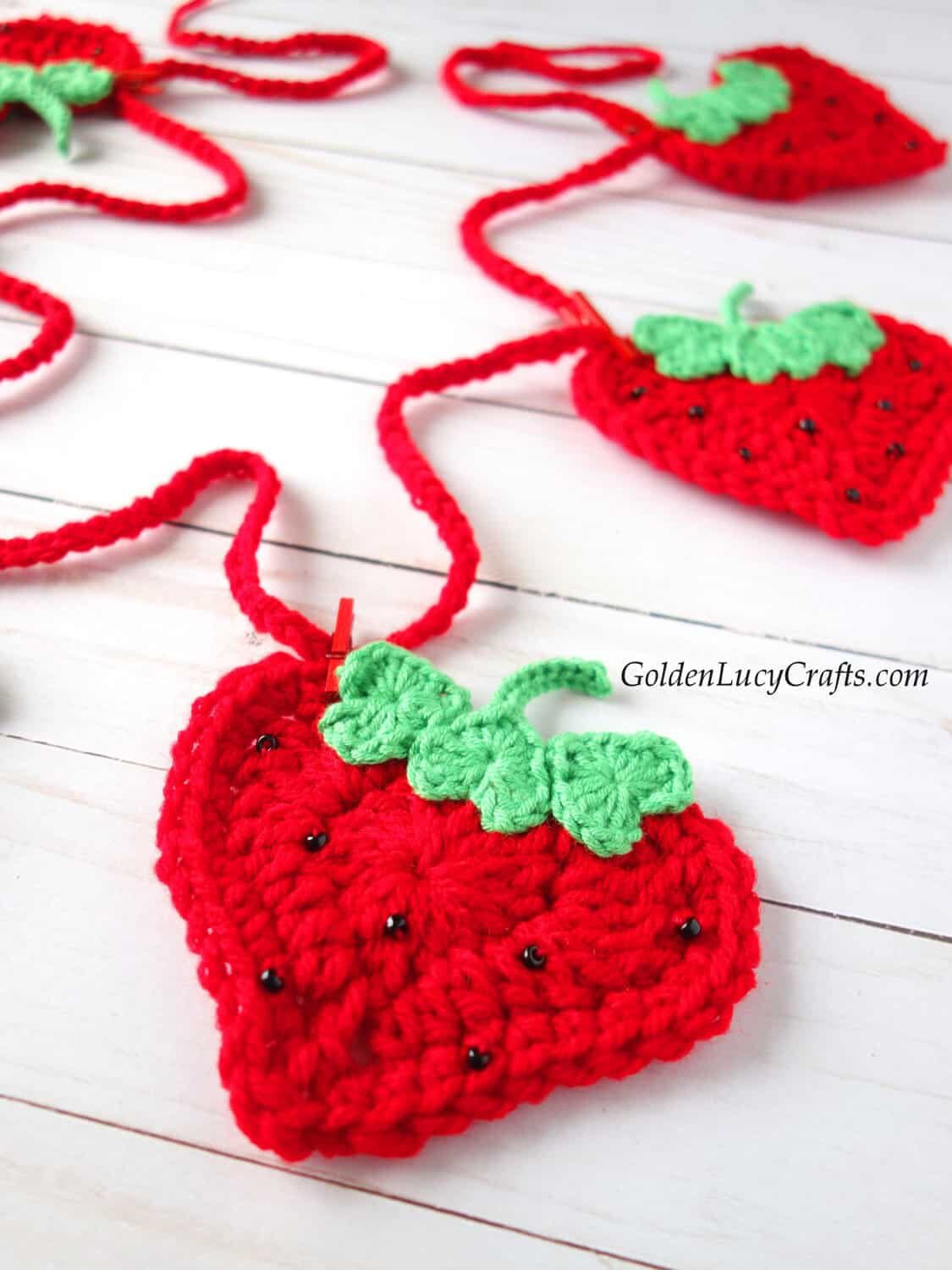 Crochet strawberry garland close up picture.