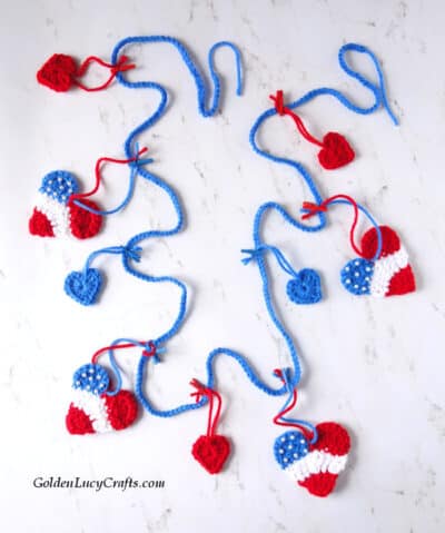 Crocheted patriotic garland made from hearts in red, white and blue.