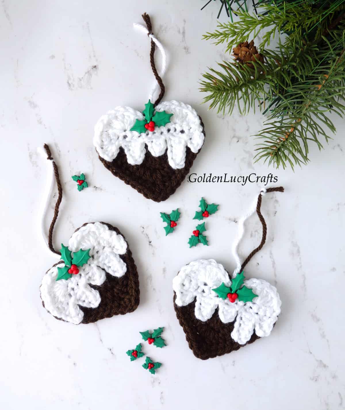 Three crochet Christmas pudding heart-shaped ornaments
