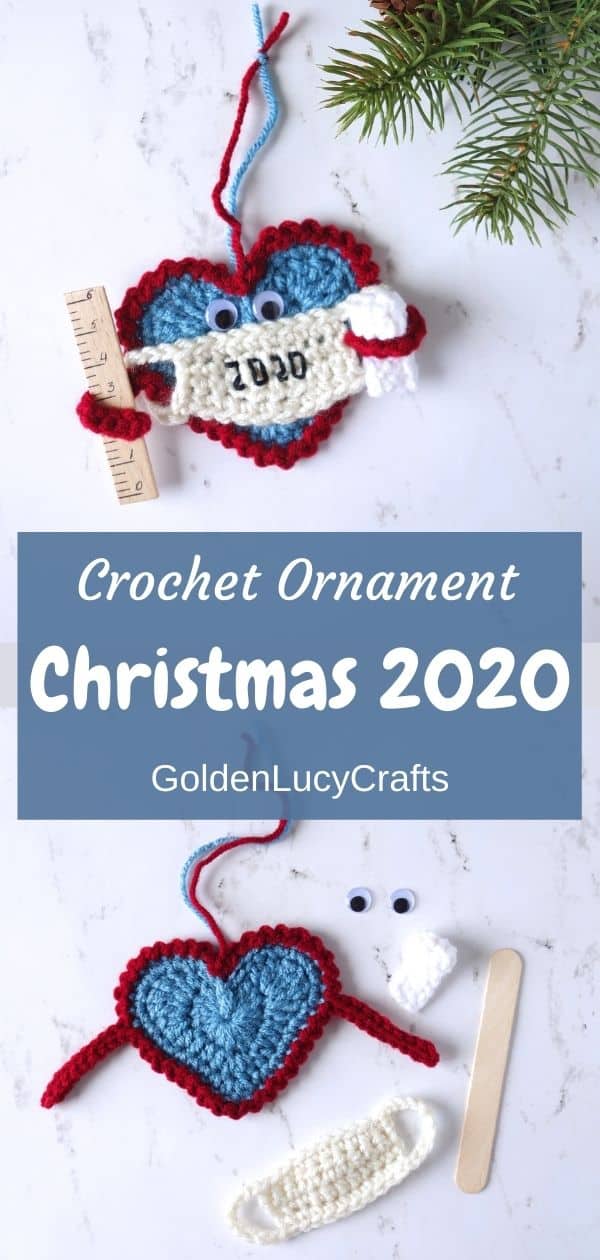 Crochet Christmas 2020 ornament. The ornament is a Heart wearing a mask and holding a ruler in one arm and a toilet paper roll in the other.
