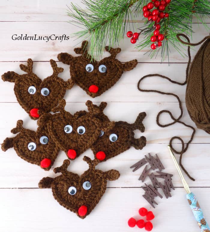 Crochet reindeer appliques, craft clothespins, red pompoms, crochet hook and brown yarn 
