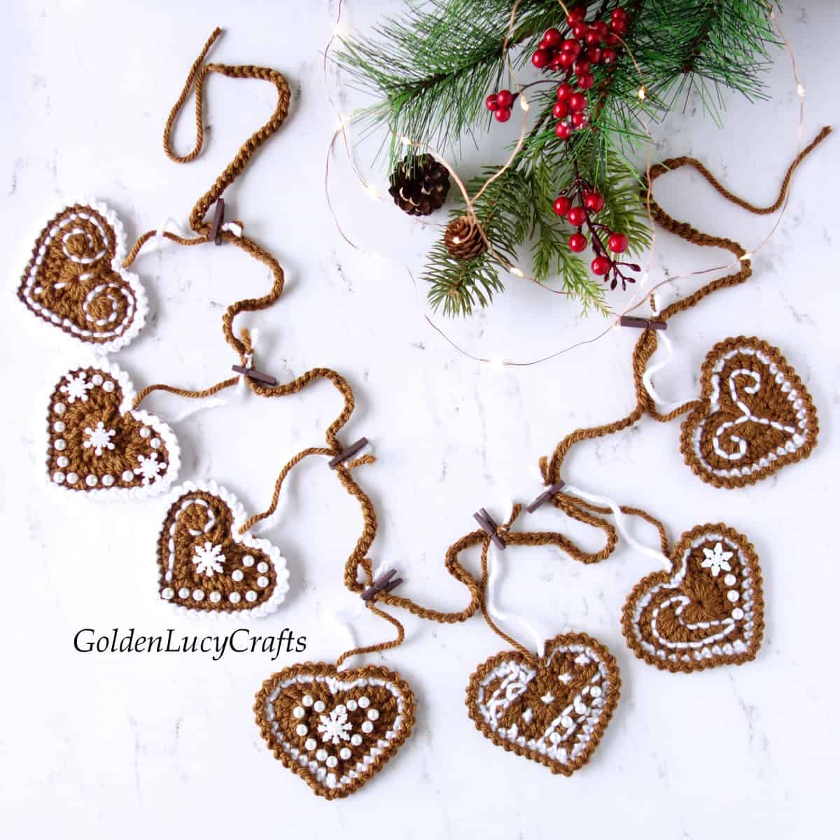 Crocheted gingerbread garland laying on the flat surface