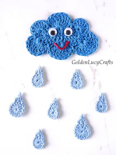 Crochet smiling cloud and raindrops appliques.