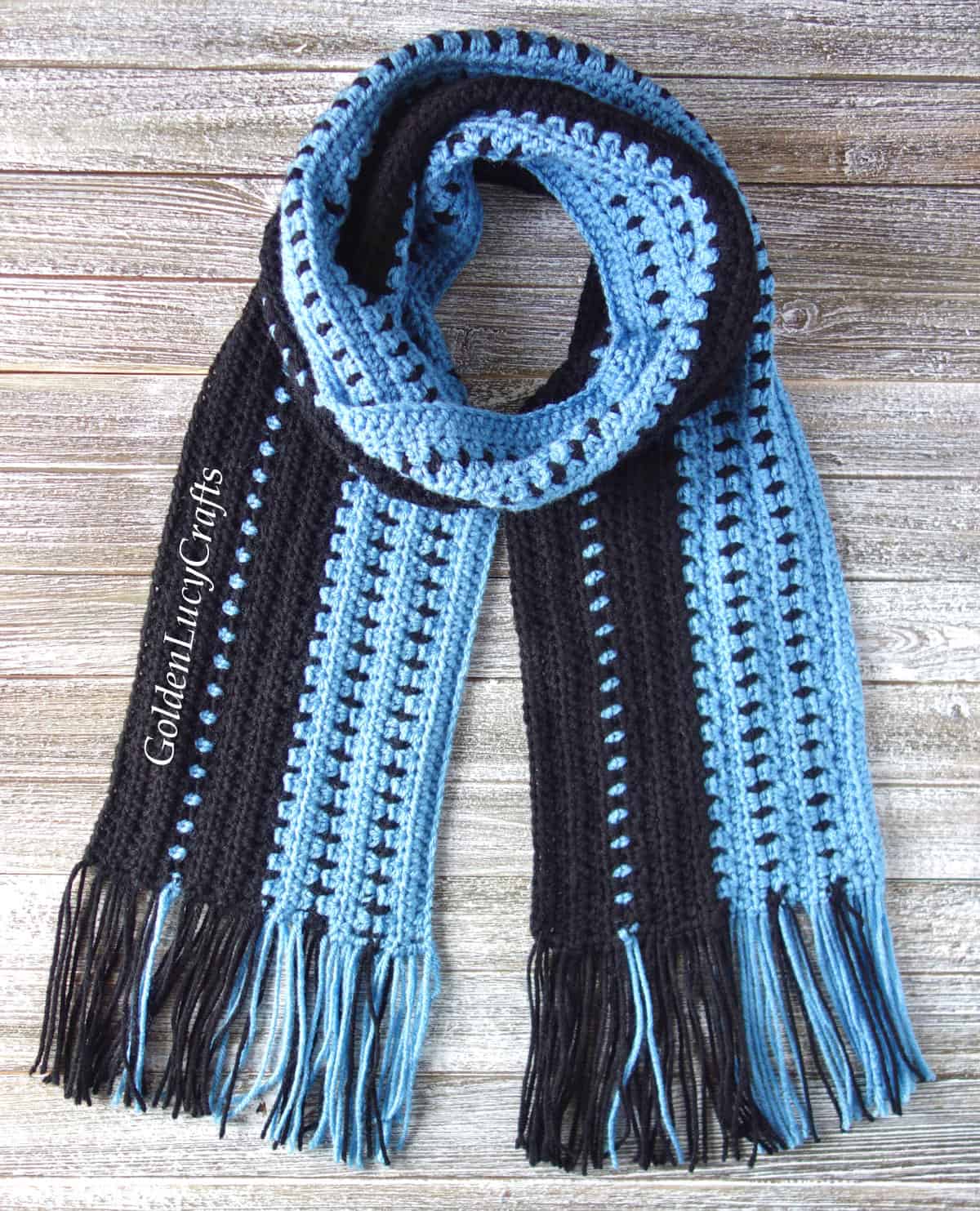 Crochet scarf in blue and black colors.