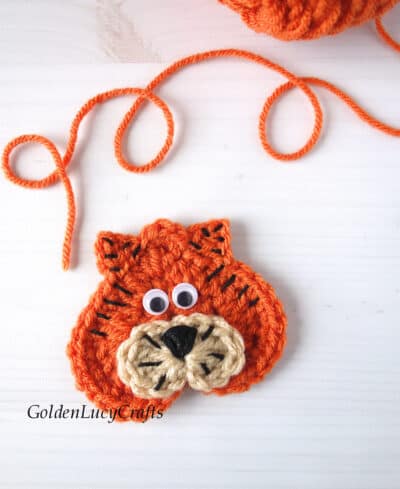 Crochet heart-shaped tiger applique.