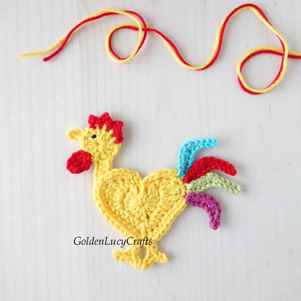 Crocheted colorful rooster applique.
